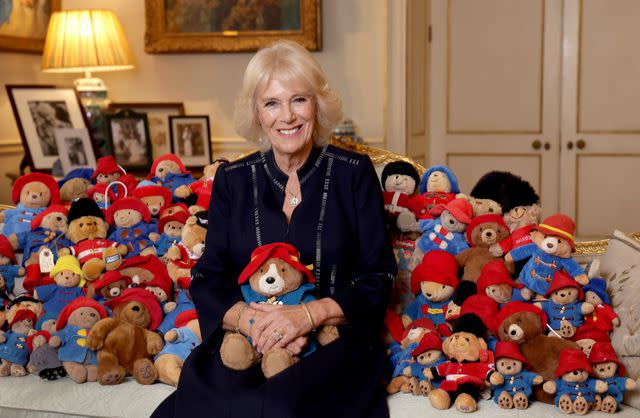 Chris Jackson/Getty Queen Camilla poses with Paddington Bears left at at royal residences as tributes to Queen Elizabeth, which were cleaned and donated