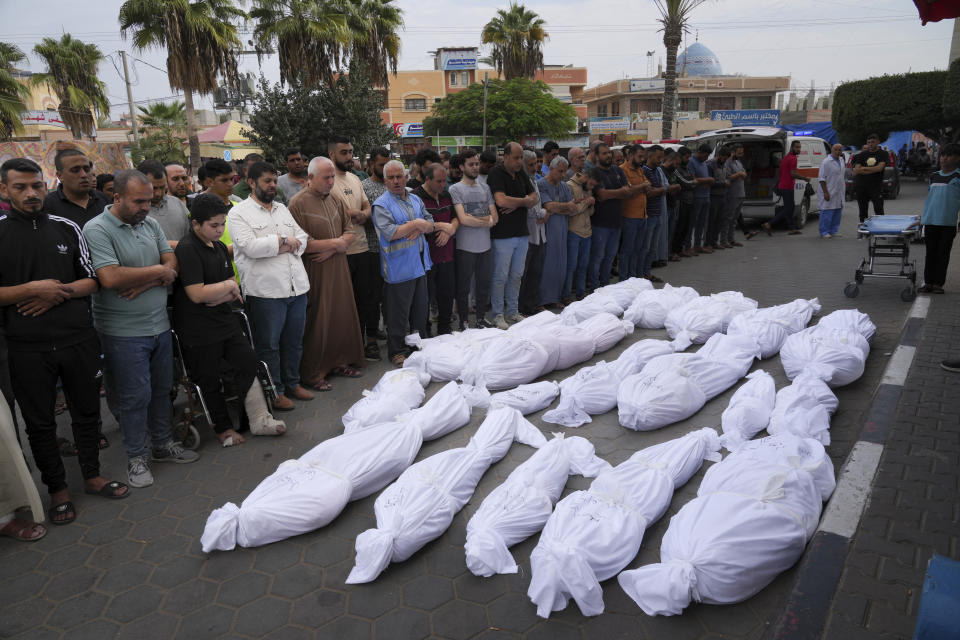 Palestinians pray for their relatives killed in the Israeli bombardment of the Gaza Strip in Deir al Balah on Friday, Oct.27, 2023. (AP Photo/Hatem Moussa)