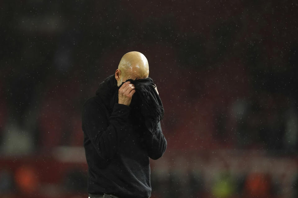 Manchester City's head coach Pep Guardiola reacts after the English Premier League soccer match between Manchester United and Manchester City at Old Trafford in Manchester, England, Sunday, March 8, 2020. (AP Photo/Dave Thompson)