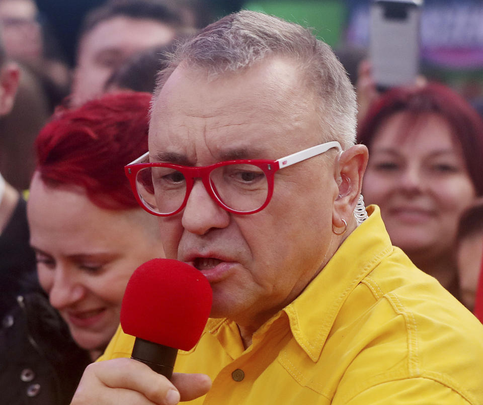 Jerzy Owsiak, founder and leader, of the Great Orchestra of Christmas Charity, one of Poland's largest charities organizations, speaks during the finale of a yearly fundraiser, in Warsaw, Poland, Sunday, Jan. 12, 2020. The charity raises money for life-saving medical equipment for public hospitals, and is a beloved tradition among many Poles. (AP Photo/Czarek Sokolowski)