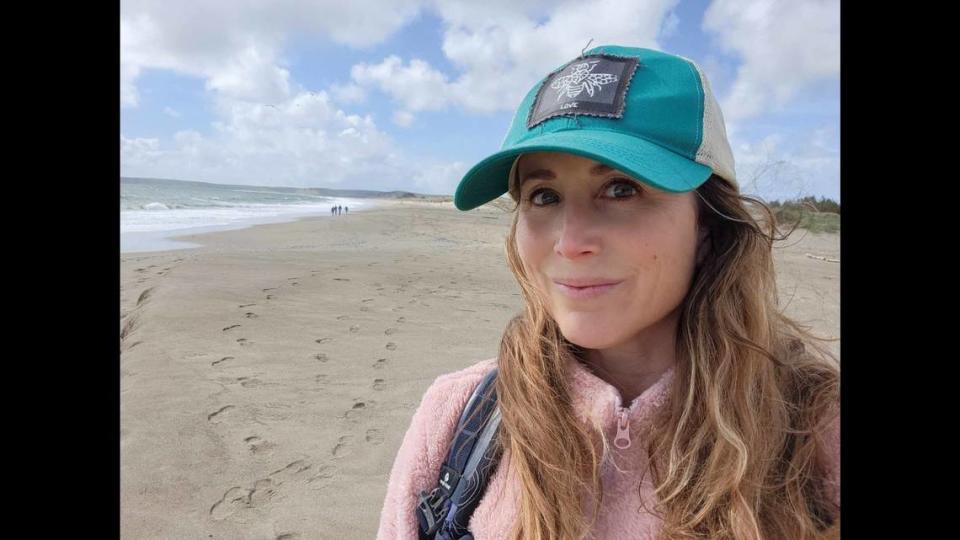 Nicole Hope stands on Limantour Beach, where she found thousands of velella velella.