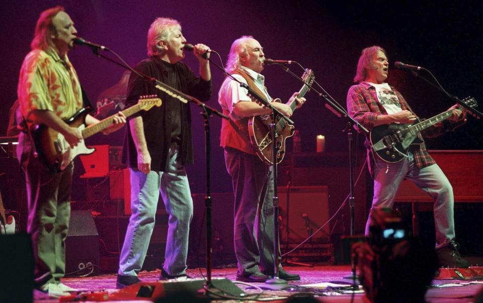 FILE - Stephens Stills, Graham Nash, David Crosby and Neil Young, from left, harmonize on a version of Young's "Southern Man" during a concert in Los Angeles, on Feb 12, 2000. Crosby, the brash rock musician who evolved from a baby-faced harmony singer with the Byrds to a mustachioed hippie superstar and an ongoing troubadour in Crosby, Stills, Nash & (sometimes) Young, has died at age 81. His death was reported Thursday, Jan. 19, 2023, by multiple outlets. (AP Photo/E.J. Flynn, File)