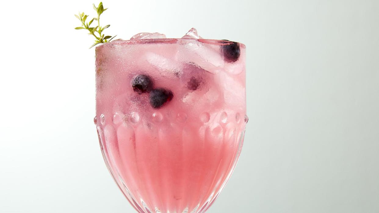 thyme blueberry lemonade with a sprig of fresh thyme