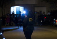 <p>An agent with the Bureau of Alcohol, Tobacco, Firearms and Explosives stands outside the family home, in Baltimore, Aug. 26, 2018, of the suspect in a mass shooting earlier in the day in Jacksonville, Fla. (Photo: Jose Luis Magana/AP) </p>