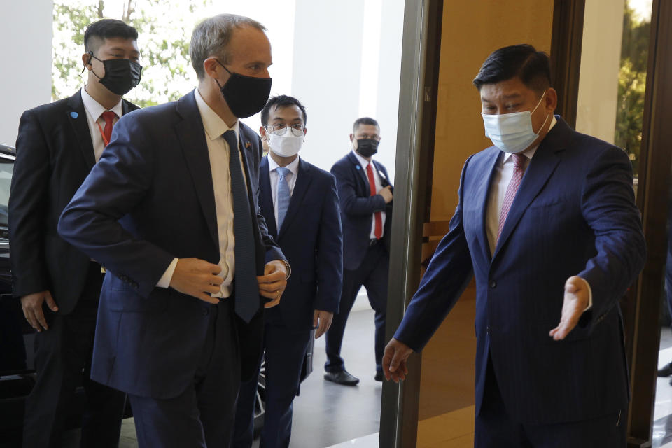 Britain's Foreign Secretary Dominic Raab, front left, meets Cambodian's Environment Minister Say Sam Al , right, on his arrival at Environment Ministry in Phnom Penh, Cambodia Wednesday, June 23, 2021. Raab is on his two-day official visit to Cambodia. (AP Photo/Heng Sinith)