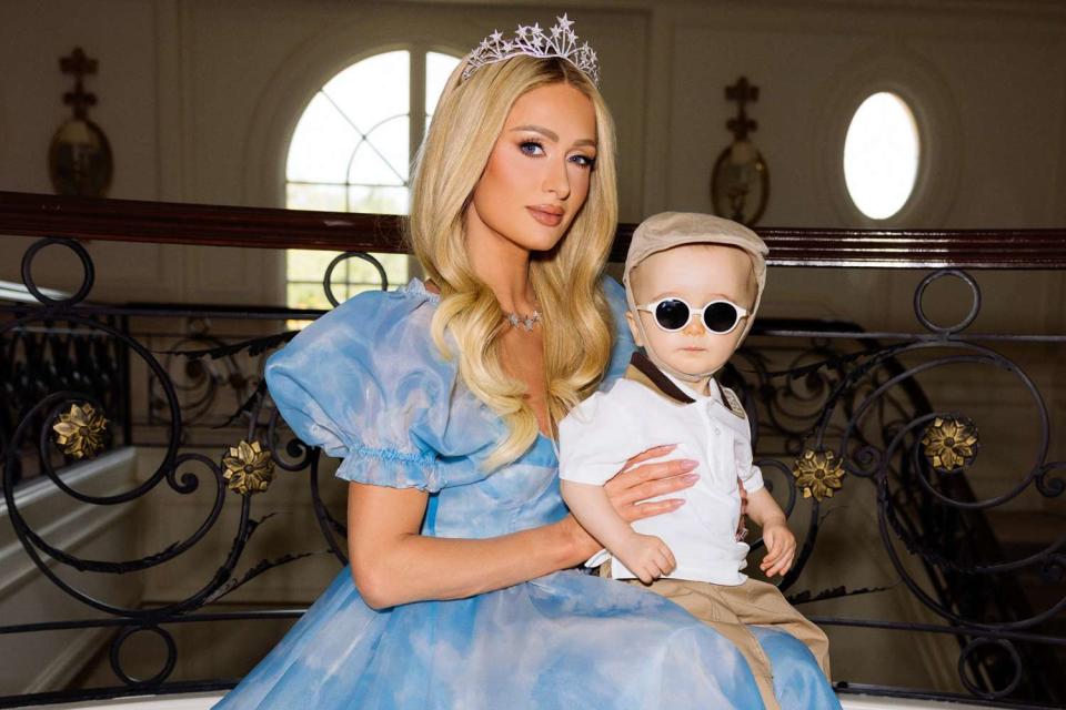 <p>Kevin Ostajewski</p> Paris Hilton poses with son Phoenix as they celebrate his first birthday