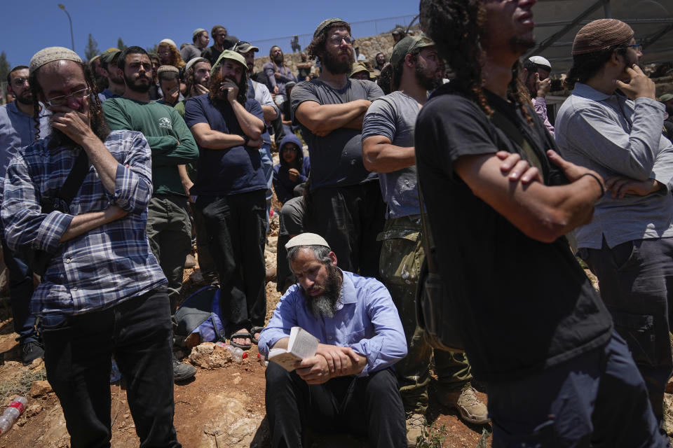 Mourners attend the funeral of Nachman Mordoff, 17, in the West Bank Israeli settlement of Shilo, Wednesday, June 21, 2023. Mordoff was among four Israelis killed by two Palestinian attackers that opened fire at a restaurant and gas station near the Israeli settlement of Eli in the West Bank on Tuesday. The attackers were killed by Israeli fire as violence continued to roil the West Bank. (AP Photo/Ohad Zwigenberg)