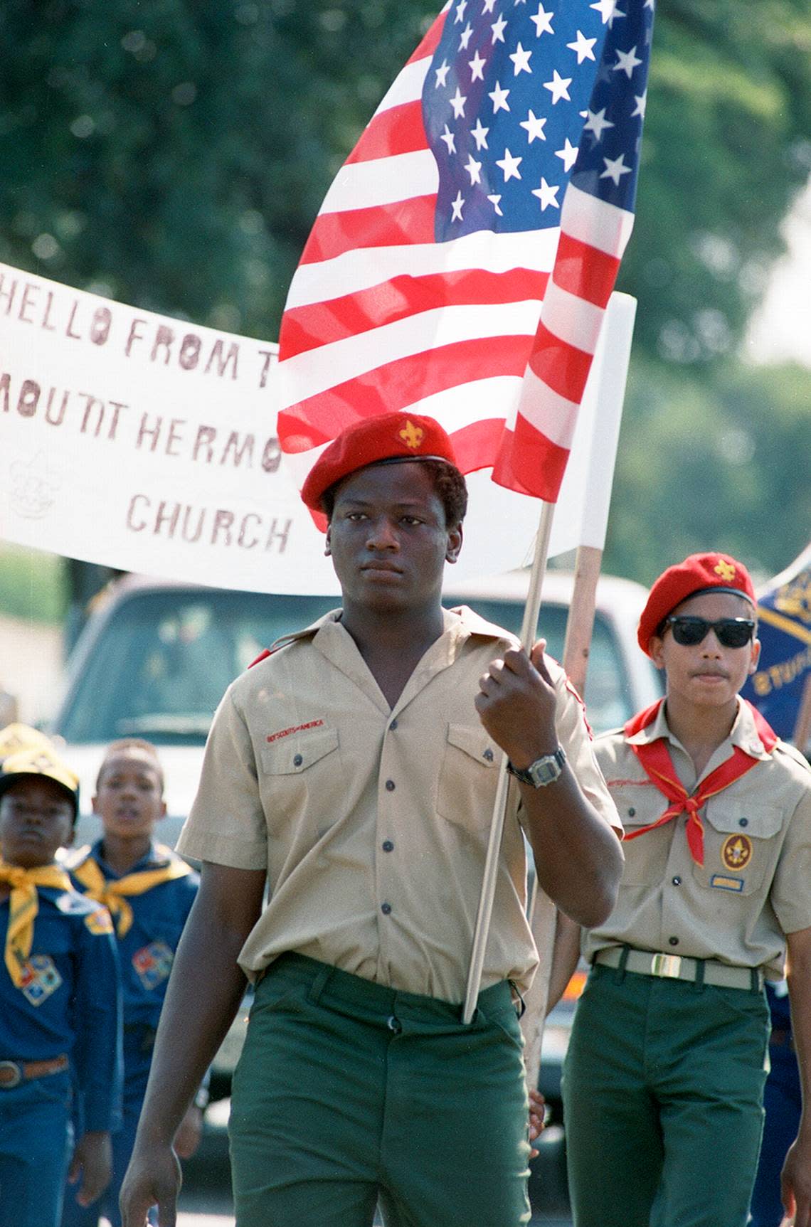 Boy Scout John Rawls leads a group of Scouts in the Juneteenth parade along Rosedale Street in Fort Worth in 1988.