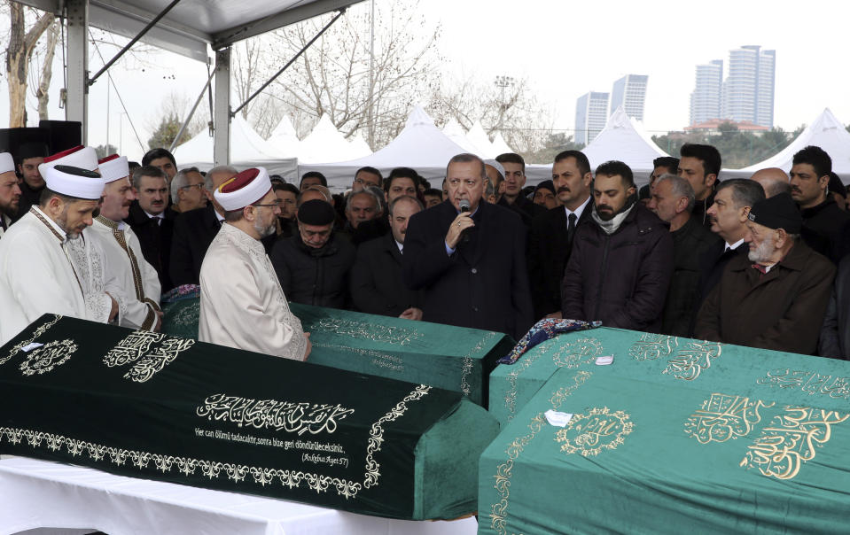 Turkey's President Recep Tayyip Erdogan, center, speaks as he joins hundreds of mourners who attend the funeral prayers for nine members of Alemdar family killed in a collapsed apartment building, in Istanbul, Saturday, Feb. 9, 2019. Erdogan says there are "many lessons to learn" from the collapse of a residential building in Istanbul where at least 17 people have died.(Presidential Press Service via AP, Pool)