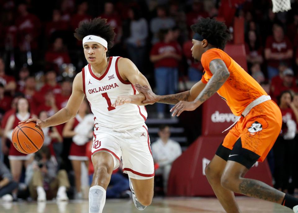 Oklahoma's Jalen Hill (1) drives up court as Oklahoma State's Quion Williams (13) defends during the men's Bedlam college basketball game between the University of Oklahoma Sooners and the Oklahoma State Cowboys at Lloyd Noble Center in Norman, Okla., Tuesday, Jan.3, 2023. OSU beat 71-61.