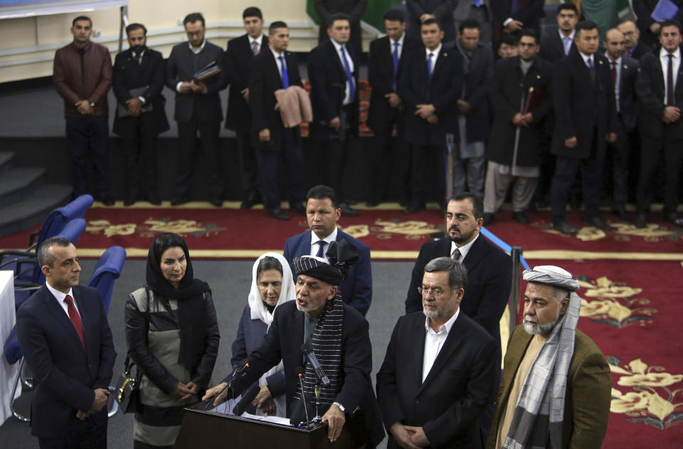 Afghanistan's President Ashraf Ghani, center, speaks to journalists at the Independent Elections Commission, in Kabul, Afghanistan, Sunday, Jan. 20, 2019. Ghani and Chief Executive Abdullah Abdullah on Sunday registered to run for president later this year, setting up a rematch after a bitterly disputed 2014 vote led to a power-sharing agreement brokered by the United States. (AP Photo/Rahmat Gul)