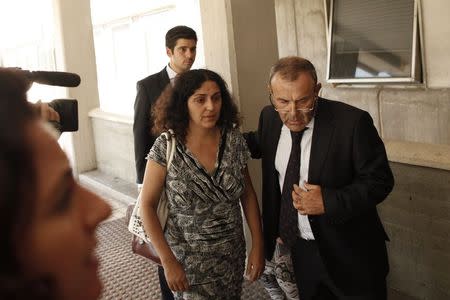 Naghemeh King (C), mother of Ashya King, arrives with her husband Brett (not pictured) and accompanied by her lawyer Juan Isidro Fernandez (R), at Malaga's Materno-Infantil Hospital, where their son is hospitalized since last Saturday, in Malaga, southern Spain, September 3, 2014. REUTERS/Jon Nazca