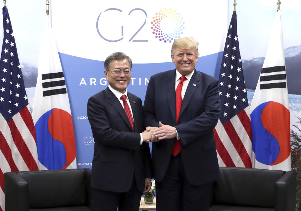 In this Nov. 30, 2018, photo, South Korean President Moon Jae-in, left, shakes hands with U.S. President Donald Trump during a meeting on the sidelines of the Group of 20 Leaders' Summit in Buenos Aires, Argentina. Moon says U.S. President Donald Trump told him he has a "very friendly view" of North Korean leader Kim Jong Un and wants to grant his wishes if he denuclearizes. (Hwang Kwang-mo/Yonhap via AP)