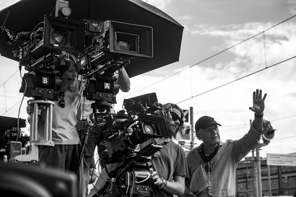 Cinematographer Erik Messerschmidt, center, and director Michael Mann, right, on the set of "Ferrari." (Lorenzo Sisti)
