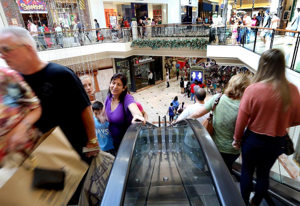 Christmas shoppers walk through the Mall at Wellington Green in Wellington.