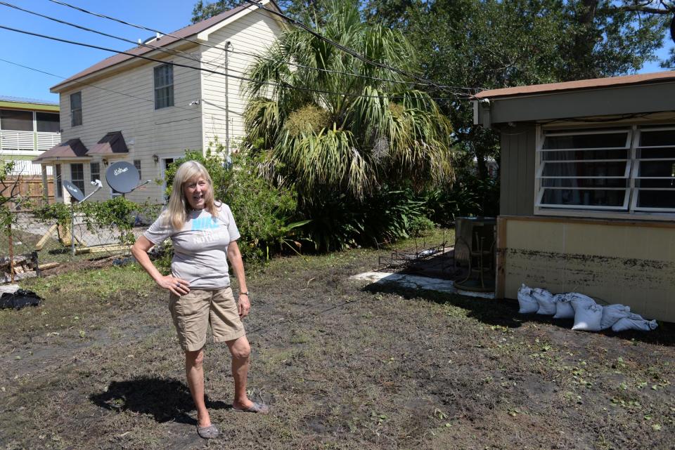 FILE - Frannie Galloway stands in her backyard, which flooded along with her house, on Lewis Avenue on Tybee Island on Tuesday, Sept. 12, 2017 during Hurricane Irma. The storm was a billion-dollar disaster according to NOAA, and Tybee was one of the many southeastern location that received FEMA help after the water subsided.