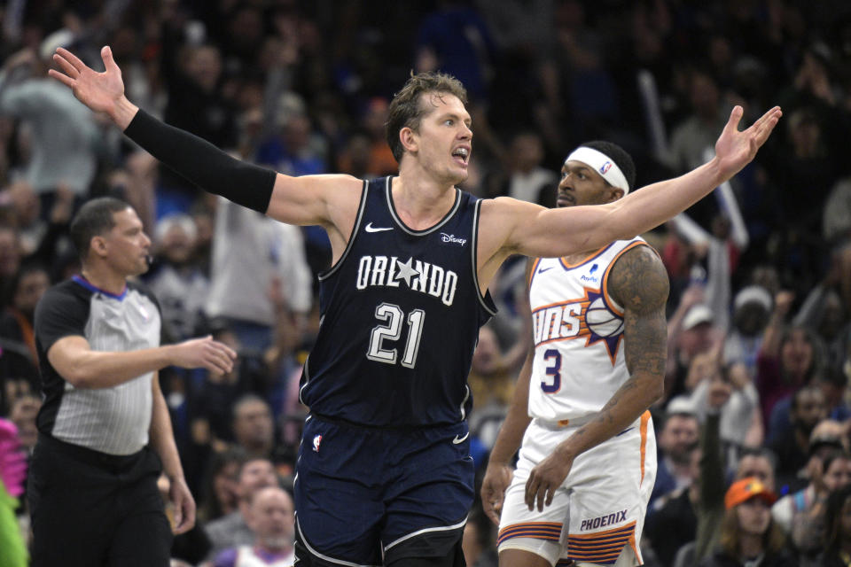 Orlando Magic center Moritz Wagner (21) celebrates after a score as Phoenix Suns guard Bradley Beal (3) looks on during the second half of an NBA basketball game, Sunday, Jan. 28, 2024, in Orlando, Fla. (AP Photo/Phelan M. Ebenhack)