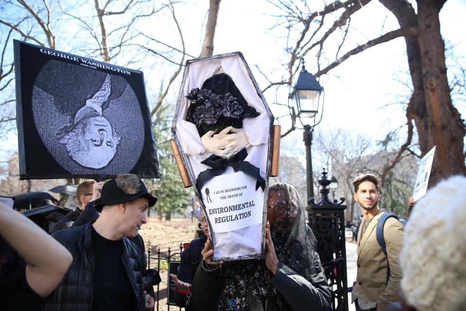 <p>A mourner holds up a coffin as he walks around Washington Square Park during the “A Mock Funeral for President’s Day” rally in New York City on Feb. 18, 2017. (Gordon Donovan/Yahoo News) </p>