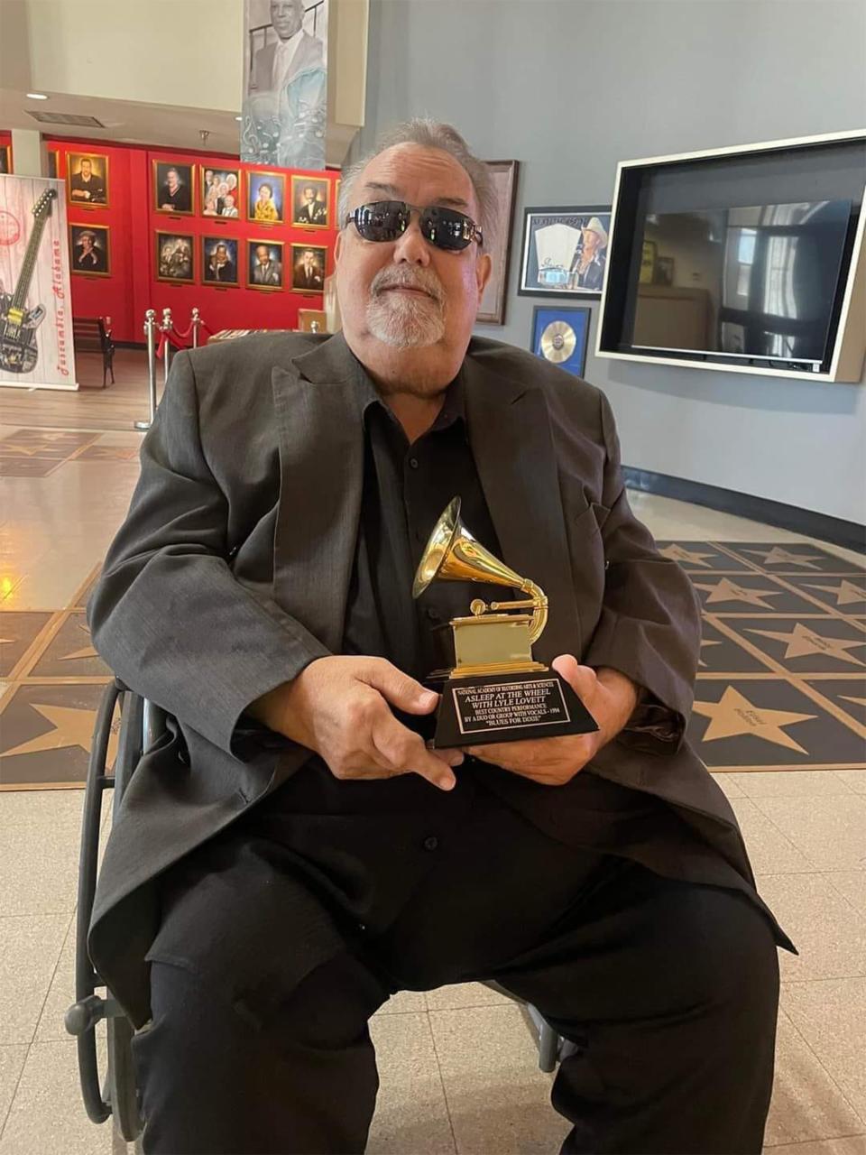 Tommy Beavers, who died on Oct. 29, displays his Grammy Award during a visit to the Alabama Music Hall of Fame in Tuscumbia this past summer.