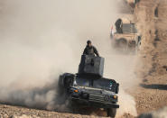 An Iraqi Special Forces soldier stands on top of a vehicle in a desert south of Mosul, Iraq February 24, 2017. REUTERS/Goran Tomasevic