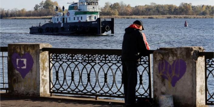 A man is fishing on the waterfront in Kherson, October 31