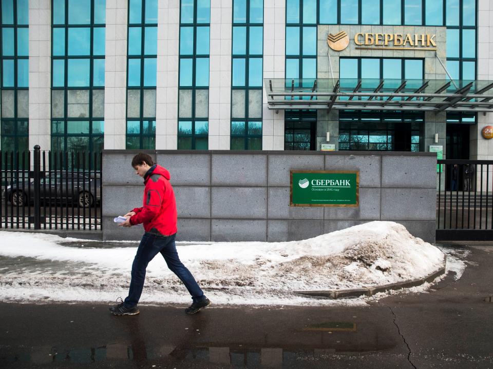A person walks by Sberbank HQ in downtown Moscow