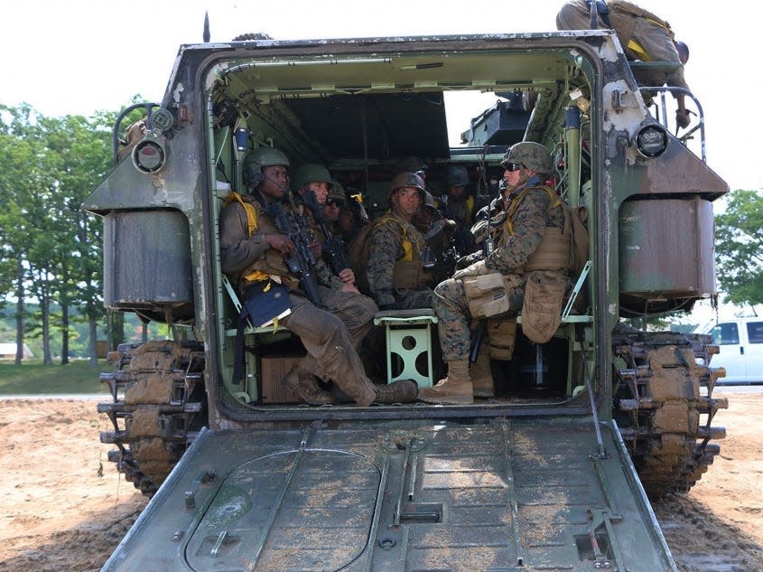 Marines aboard amphibious assault vehicle prepare for an amphibious assault.