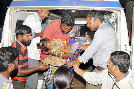 A girl is rushed for treatment after consuming a religious food offering at a temple, outside a hospital in Mysuru, December 14, 2018. REUTERS/Stringer