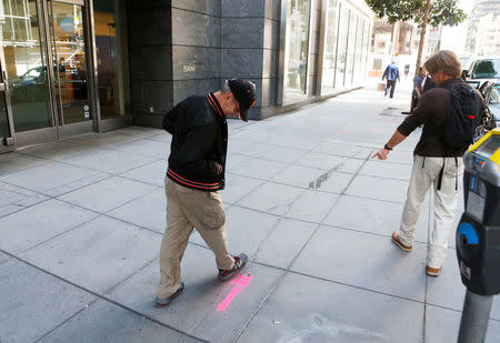 Pedestrians inspect cracks near the sinking Millennium Tower in San Francisco, California, U.S. September 14, 2016. REUTERS/Beck Diefenbach