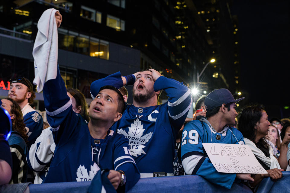 Fans react during Game 7 of an NHL hockey first-round playoff series between the Toronto Maple Leafs and the Tampa Bay Lightning in Toronto, Saturday May 14, 2022. (Christopher Katsarov/The Canadian Press via AP)