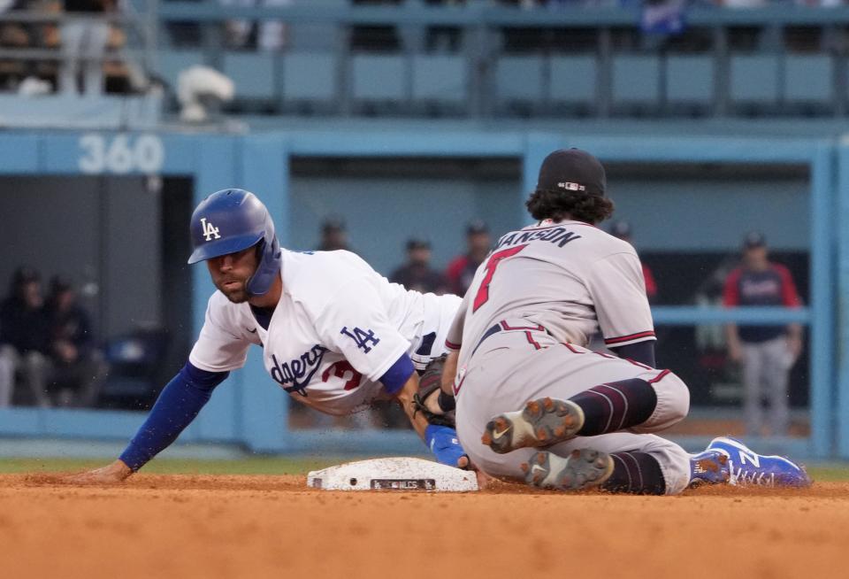 Los Angeles Dodgers third baseman Chris Taylor (3) steals second base in front of Atlanta Braves shortstop Dansby Swanson (7) in the eighth inning of Game 3 of the NLCS.