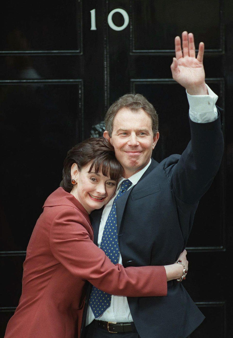 FILE - Britain's Prime Minister Tony Blair, is hugged by his wife Cherie outside No. 10 Downing Street in London, shortly after his election win, Friday May 2, 1997. Caulkin, a retired Associated Press photographer has died. He was 77 and suffered from cancer. Known for being in the right place at the right time with the right lens, the London-based Caulkin covered everything from the conflict in Northern Ireland to the Rolling Stones and Britain’s royal family during a career that spanned four decades. (AP Photo/Dave Caulkin, File)