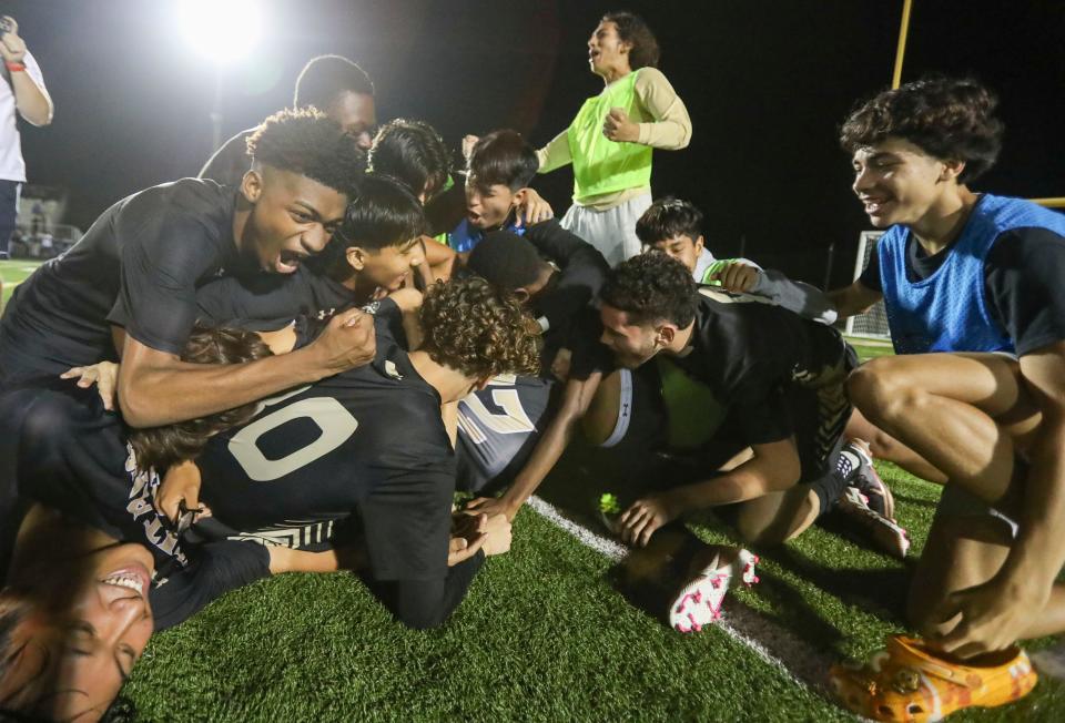 Golden Gate Titans players celebrate after defeating the Naples Golden Eagles in penalty kicks during the Class 5A District 12 game at Golden Gate High School in Naples on Thursday, Feb. 2, 2023.