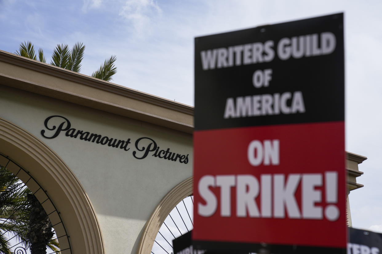 Members of the The Writers Guild of America picket outside Paramount Pictures on Wednesday, May 3, 2023, in Los Angeles. Television and movie writers declared late Monday, May 1, that they will launch an industrywide strike for the first time in 15 years, as Hollywood girded for a walkout with potentially widespread ramifications in a fight over fair pay in the streaming era. Moody's estimated the strike will likely have financial implications to major media companies. (AP Photo/Ashley Landis)