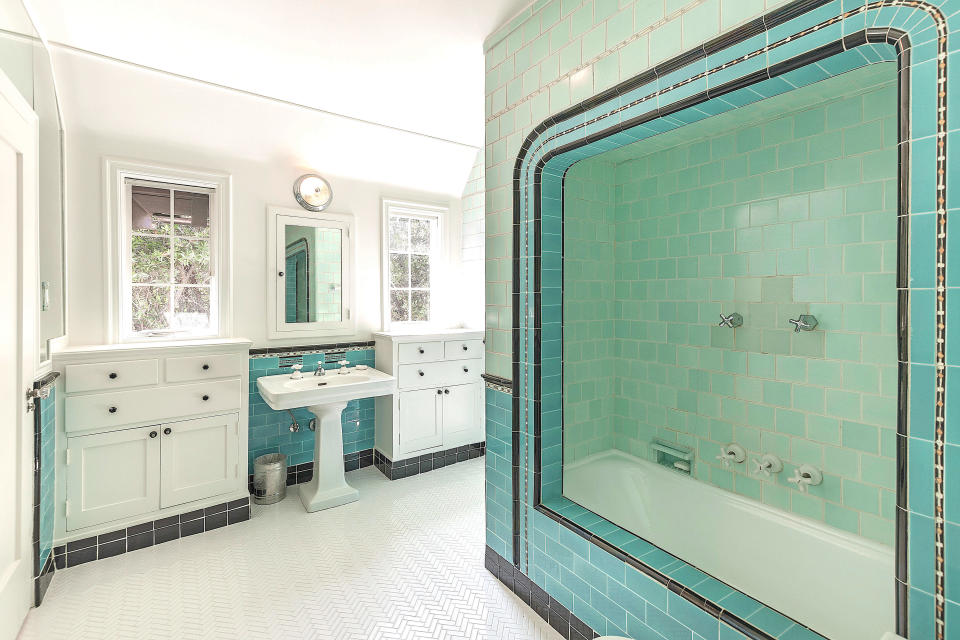 Blue tiles add a pop of color to one bathroom.