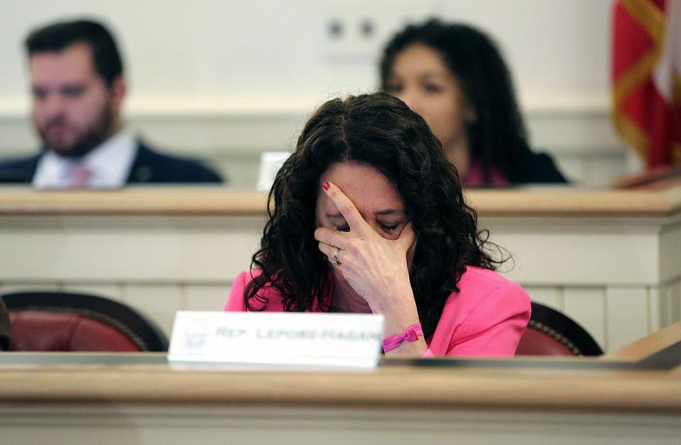 Ohio Representative Michele Lepore-Hagan wipes tears from her face during a hearing to propose amendments to the "Heartbeat Bill" which was later voted to pass through the committee and to the House floor at the Ohio Statehouse in Columbus, Ohio on Tuesday, April 9, 2019. (Brooke LaValley/Columbus Dispatch via AP)