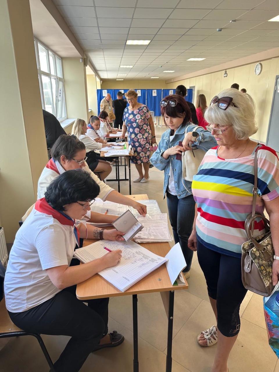 A woman checks in to vote at a polling location in Russian-occupied Ukraine during Russian elections in September 2023.