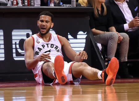 Toronto Raptors guard Cory Joseph (6) sits against an advertising board after falling chasing a loose ball against Miami Heat in game one of the second round of the NBA Playoffs at Air Canada Centre. The Heat won 102-96. Mandatory Credit: Dan Hamilton-USA TODAY Sports