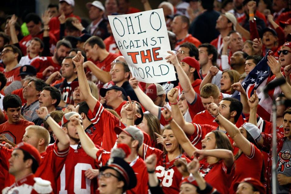 An Ohio State fan holds a sign that reads "Ohio against the world".