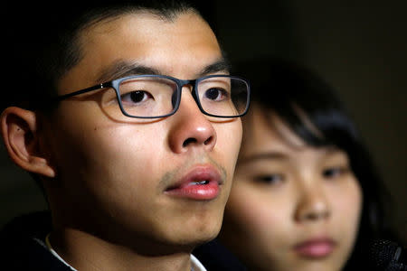 Former student leader Joshua Wong stands beside student activist Agnes Chow after being released on bail at the High Court in Hong Kong, China January 23, 2018. REUTERS/Bobby Yip