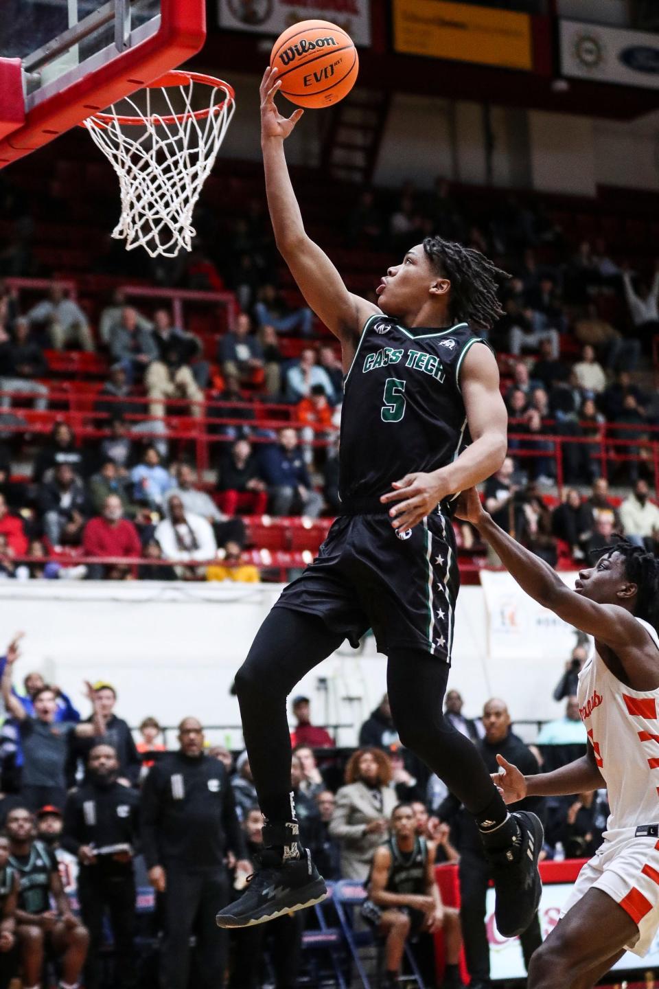 Detroit Cass Tech's Darius Acuff (5) makes a layup against  Birmingham Brother Rice during the second half at Calihan Hall in Detroit on Friday, March 3, 2023.