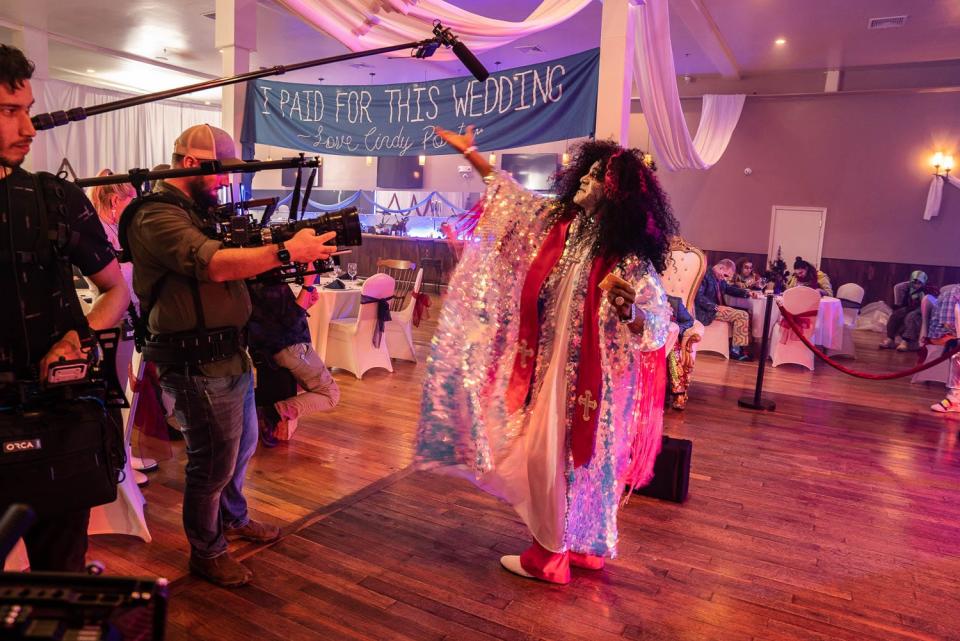 A wedding party scene from 'The Zombie Wedding,' a horror-comedy movie from Weekly World News Studios using the city of Vineland as the shooting location. Cinematographer Jim Powers shoots the Reverend Harry Crump (Seth Gilliam) during the reception.