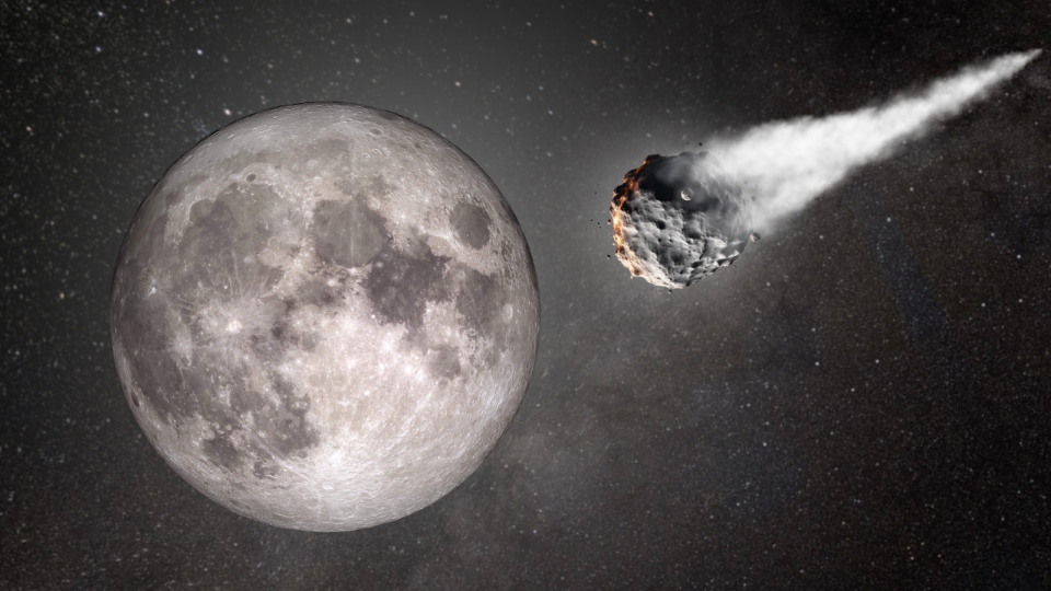  A large light grey sphere with darker grey patches next to an irregularly shaped grey rock followed by a trail of white smoke. 