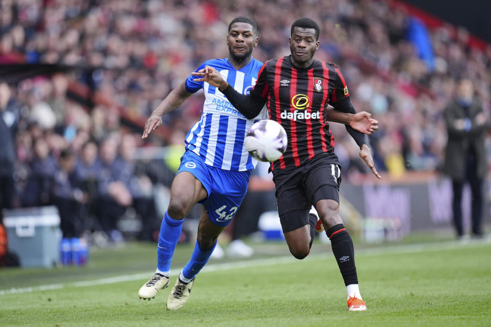 Bournemouth's Dango Ouattara, right, and Brighton and Hove Albion's Odeluga Offiah, left, challenge for the ball during the English Premier League soccer match between AFC Bournemouth and Brighton & Hove Albion in Bournemouth, England, Sunday, April 28, 2024. (Adam Davy/PA via AP)