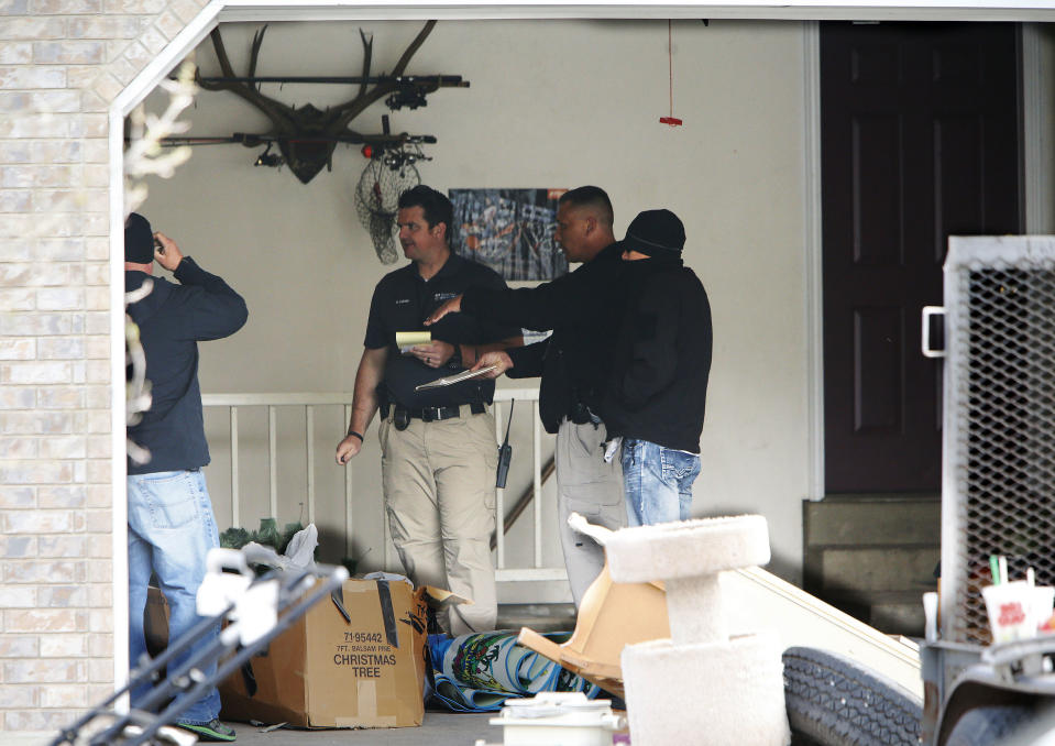 Pleasant Grove Police investigate the scene where seven infant bodies were discovered and packaged in separate containers at a home in Pleasant Grove, Utah, Sunday, April 13, 2014. According to the Pleasant Grove Police Department, seven dead infants were found in the former home of Megan Huntsman, 39. Huntsman was booked into jail on six counts of murder. (AP Photo/Deseret News, Jeffrey D. Allred) MANDATORY CREDIT