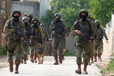 Israeli forces patrol as they search for a Palestinian gunman near Nablus, in the Israeli-occupied West Bank March 17, 2019. REUTERS/Mohamad Torokman