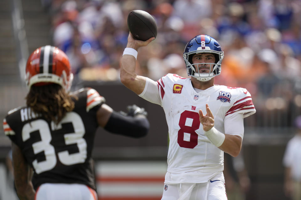 New York Giants quarterback Daniel Jones (8) passes as Cleveland Browns safety Ronnie Hickman (33) applies pressure during the first half of an NFL football game, Sunday, Sept. 22, 2024 in Cleveland. (AP Photo/Sue Ogrocki)