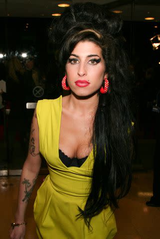 <p>JM Enternational/Getty</p> Amy Winehouse attends the red carpet at the BRIT Awards 2007 at Earls Court in London on February 14, 2007