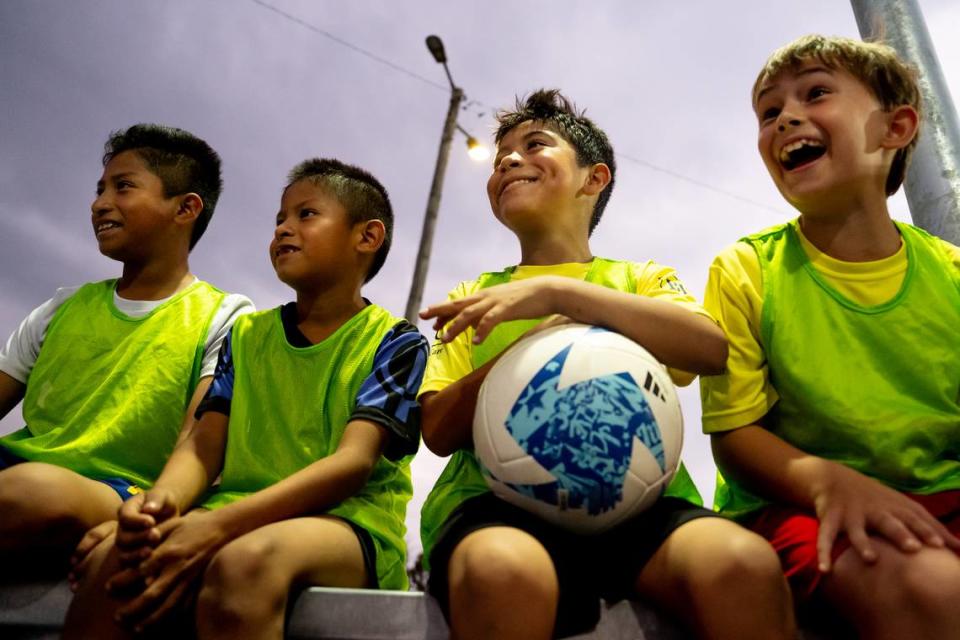 From left: Yahir Morales, 11, Angel Morales, 8, Manuel Tehandon, 8, and Aidan Smith, 9, all of Collinsville, all watch as St. Louis City SC players play soccer with teammates on Thursday, Oct. 26, 2023, during the dedication of a community mini pitch at Granby Park in Fairmont City. Brian Munoz/Brian Munoz