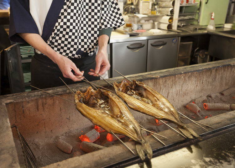 Fish being grilled inside the shop